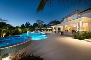 a swimming pool in front of a house at Sugar Hill - Fiddlesticks villa in Saint James +34 photos