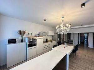 a kitchen and dining room with a chandelier at BeeFree WhirlpoolSuiteXL33-FreeParking-FastWiFi in Passau