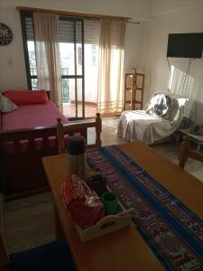 a living room with two beds and a table and a table sidx sidx at Dpto AR in San Clemente del Tuyú