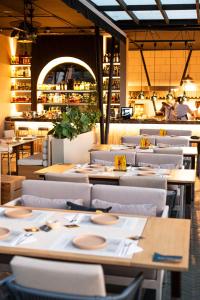 a dining room with tables and chairs and a restaurant at 1616 Hotel Medellin in Medellín