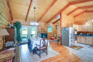 a kitchen with a table and a refrigerator at Serene Valley Bend Cabin Rental 7 Private Acres! in Valley Bend