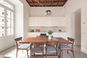 een keuken en eetkamer met een houten tafel en stoelen bij MC House Como con Posto Auto in Como