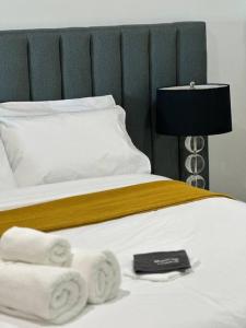 a bedroom with a bed with towels on it at Absolute Beachfront at the Pier Glenelg in Adelaide