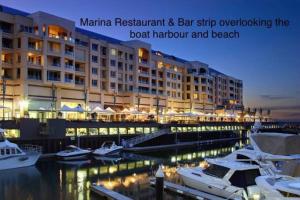 a marina restaurant and bar ship overloading the boat harbor and beach at Absolute Beachfront at the Pier Glenelg in Adelaide