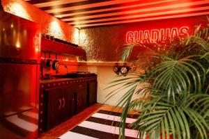 a kitchen with a red neon sign on the wall at Casa completa en Guaduas in Guaduas