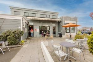 a patio with tables and chairs in front of a building at Downtown Drift-Hot Tub,Sauna,Bikes,Pet Friendly in Arcata