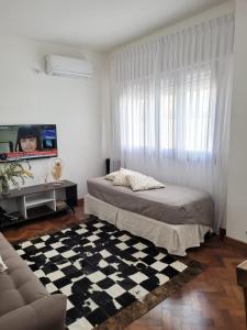 a bedroom with a bed and a checkered floor at Departamento céntrico y espacioso en Río Cuarto. in Río Cuarto