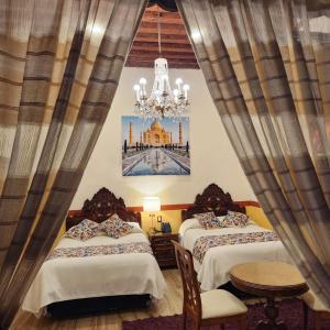 Postel nebo postele na pokoji v ubytování HOTEL CASA BAEZ