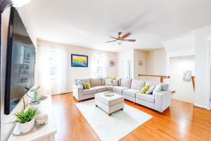 a living room with a couch and a tv at Seaside Village --- #3 in Ocean City