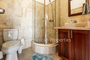 a bathroom with a shower and a toilet and a sink at Novus Mare, Cabarete by AllDominicanProperties! in Cabarete