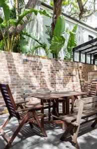 a picnic table and two chairs and a brick wall at A Charming Sunny Terrace in the Heart of Newtown in Sydney