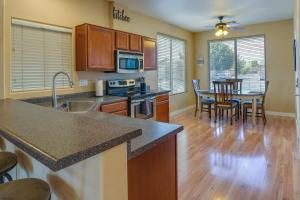 a kitchen and dining room with a table and chairs at Bright Peoria Home with Gas Grill and Fire Pit! in Peoria