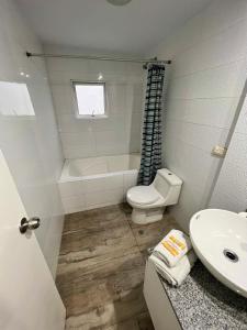 a bathroom with a toilet and a sink at DEPARTAMENTO con VISTA AL MAR in Lima