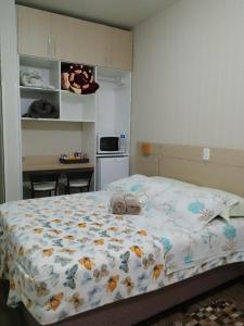 a bedroom with a bed with towels on it at Pousada Caminho das Rosas - Gramado in Gramado