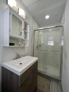 a bathroom with a sink and a shower at Two Bedrooms Marpole Vancouver in Vancouver