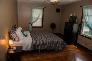 a bedroom with a bed with pillows and a television at Schillhaus in Louisville