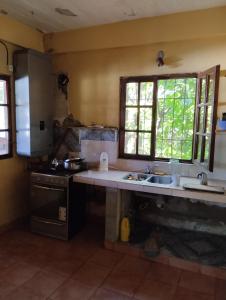 una cucina con lavandino e piano cottura di Scenario Yguazu a Puerto Iguazú