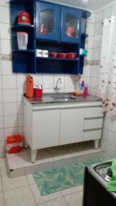 a toy kitchen with blue cabinets and a sink at Big Hostel Brasil in Manaus