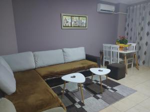 a living room with a couch and a table at Bral Apartments in Durrës