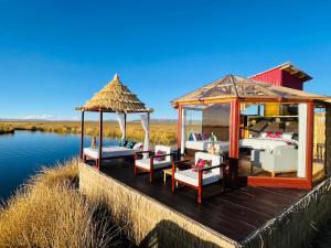 a gazebo on a dock on a body of water at Titicaca Ecolodge Perú in Puno