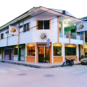 a building with a motorcycle parked in front of it at Hotel Mango Cafe in Tela