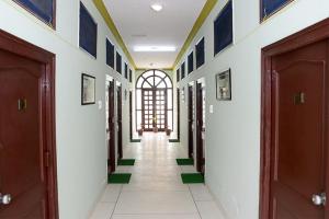 a hallway of a building with two doors at Collection O 4255 Day Night Guest House And Restaurant in Mahāmandir