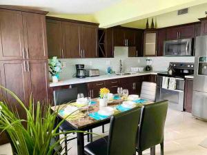 a kitchen with a table and chairs in a kitchen at Executive House Miami, Close to Airport, Beach in Miami