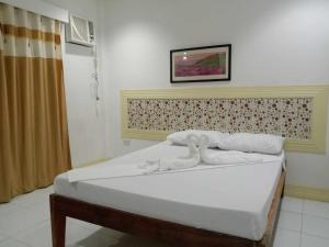 Postel nebo postele na pokoji v ubytování Bountiful Inn