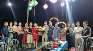 a group of people posing for a picture in front of a table at Trang An Homestay in Ninh Binh