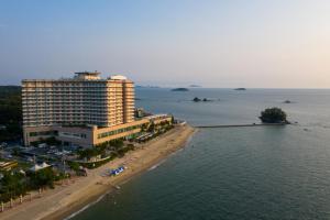 a large building on the beach next to the water at Beache Palace in Boryeong