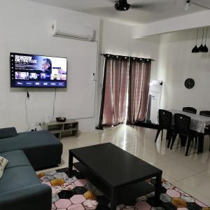 a living room with a couch and a table at Ummik Homestay in Tawau