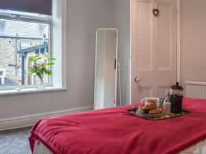 a table with a plate of food on a red blanket at Lavender House in Barnoldswick