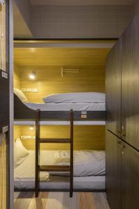 a room with two bunk beds in it at WORK INN at Taipei 101 in Taipei