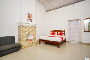 a bedroom with a bed and a fireplace at OYO Hotel Merimaid in Munnar