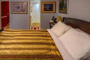 a bedroom with a large bed with a yellow blanket at Cypress Fairway Village in Wimberley
