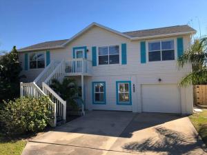 a house with a white and blue at Swansea-by-the-Sea -- Spacious home - heated pool, hot tub, walk to beach! in Ormond Beach
