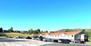 a large building with cars parked in a parking lot at Super 8 by Wyndham Hot Springs in Hot Springs