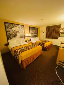 a hotel room with two beds in it at Super 8 by Wyndham Hot Springs in Hot Springs