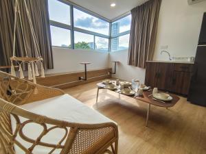 a living room with a table and chairs at DeLuma-Lebuh Acheh in George Town
