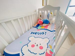 a white crib with a teddy bear blanket on it at Near Gleaneagles & Legoland-2RB WarmKitten Max7pax-COWAY WaterDispenser in Nusajaya