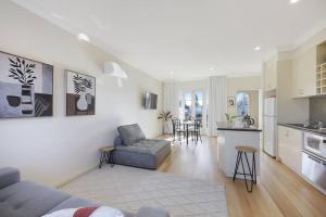 a living room with a couch and a kitchen at One bedroom apartment in CBD in Warrnambool