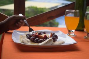 a person eating a plate of food with a fork at Reserva Natural Cascadas de Padilla in Lérida