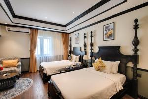 Letto o letti in una camera di Monarque Hotel Danang