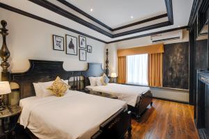 Letto o letti in una camera di Monarque Hotel Danang