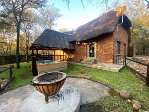 a brick house with a grill in front of it at Kudu Mal in Marloth Park