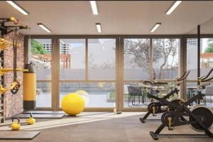 sala de fitness con gimnasio y bicicleta estática en Departamento nuevo y elegante en estación central, en Santiago