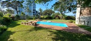 a swimming pool in a yard with a picnic table at Juanita 105 - 8 Sleeper in Margate