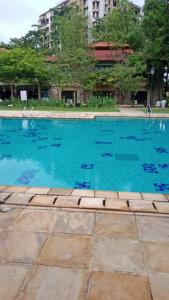a swimming pool with blue water in a city at Cyberjaya Cyberia landed house BBQ By EC in Cyberjaya