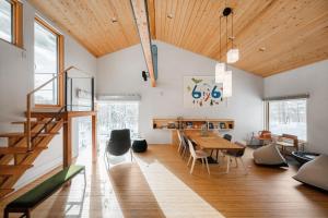 a kitchen and dining room with a table and chairs at 6ty6 Vacation Home in Niseko