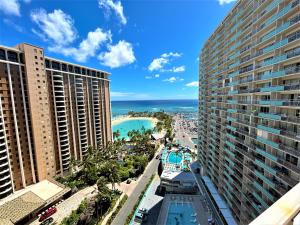 a view of the beach from the balcony of a building at Ilikai Apt 1618 - Spacious 2BR 2BA Unit with Stunning Ocean-Lagoon View in Honolulu